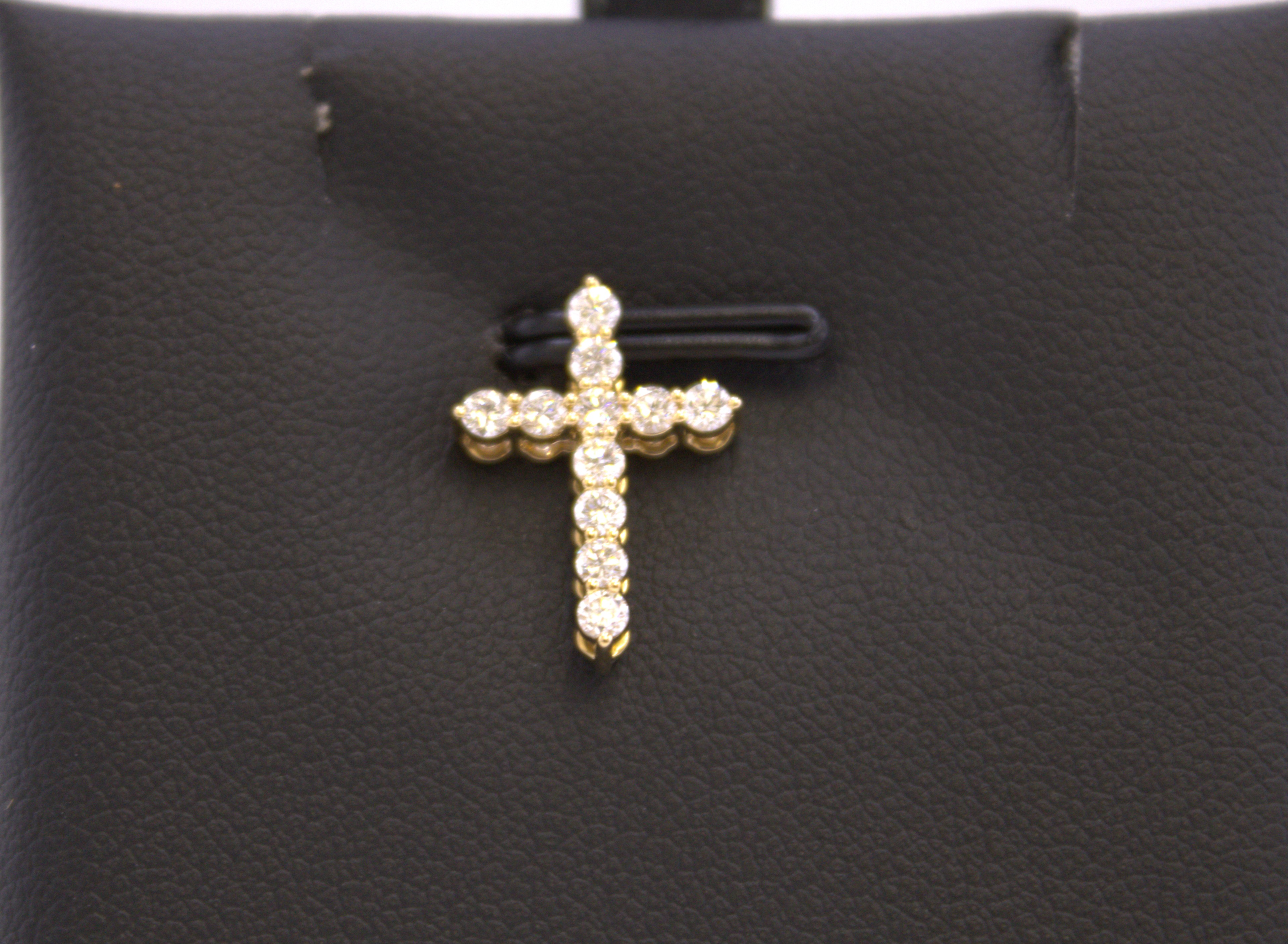 14k Yellow gold and diamond cross pendant.